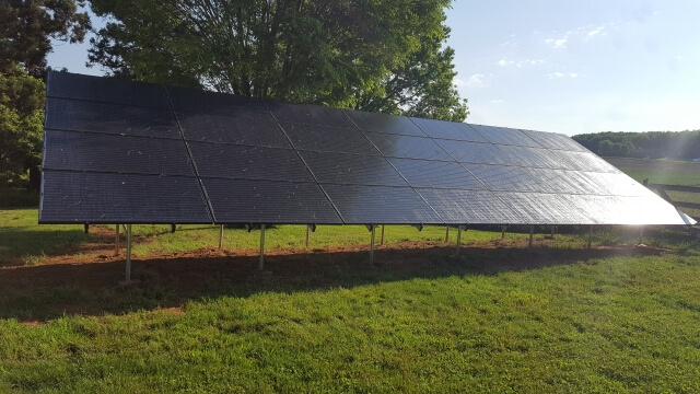 Group of solar panels near farm