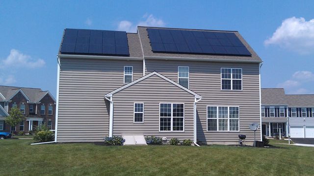 House in neighborhood with solar panels on roof