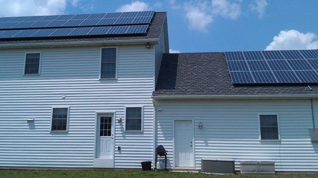 Back of a house with solar panels on roof