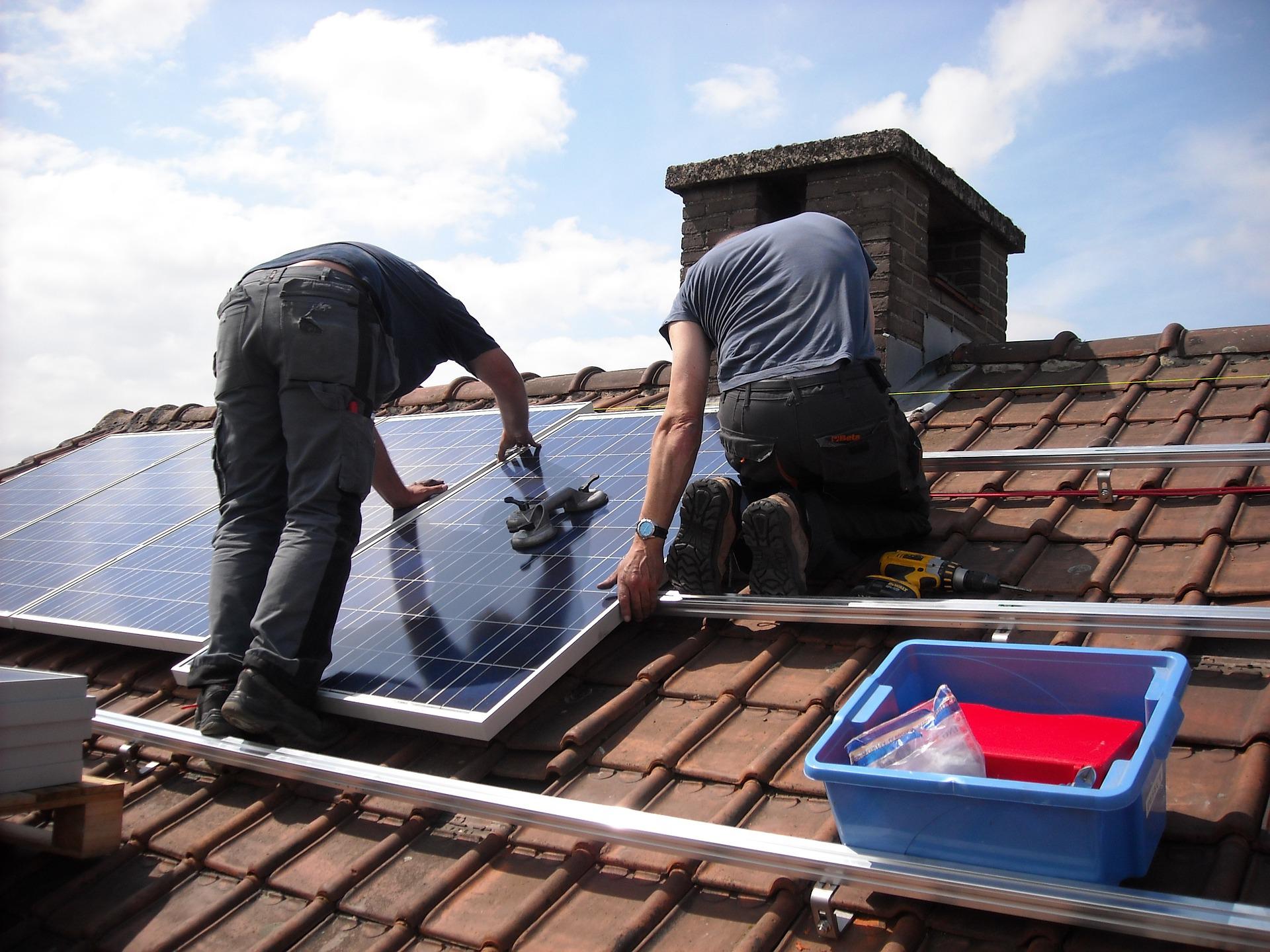 solar panels getting installed on a roof